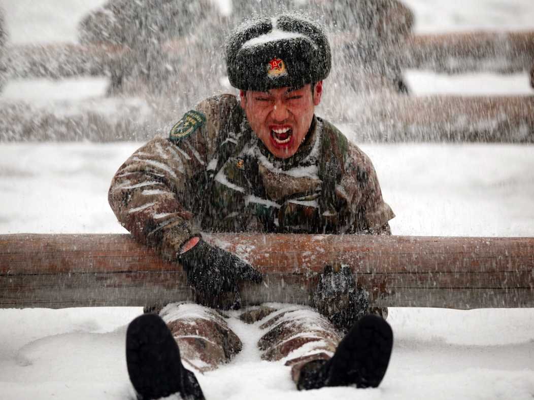 A Chinese soldier takes part in a drill during heavy snow in Heihe, Heilongjiang Province. (REUTERS/CDIC)